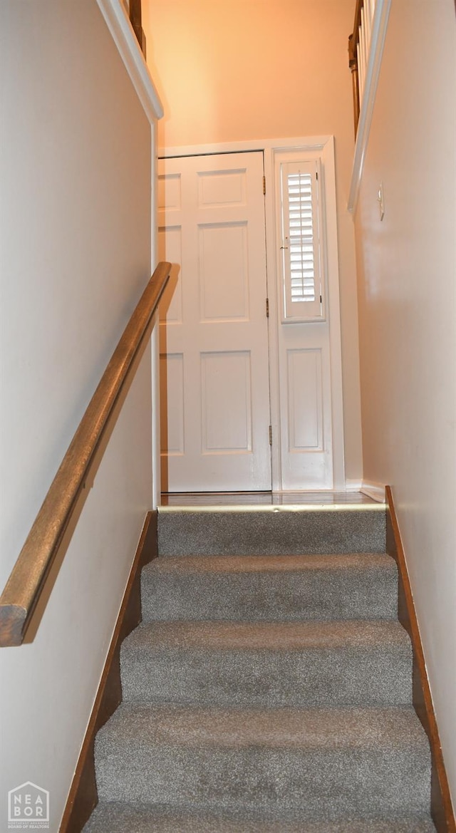 staircase featuring baseboards
