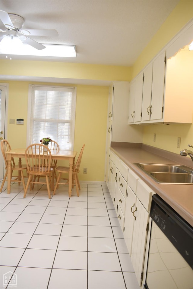 kitchen with light tile patterned floors, white cabinets, a sink, light countertops, and dishwashing machine