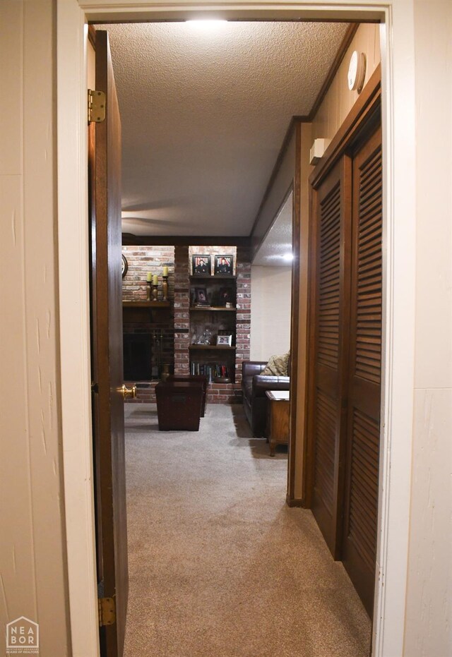 hallway featuring carpet and a textured ceiling