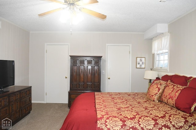 carpeted bedroom with crown molding, a ceiling fan, and a textured ceiling