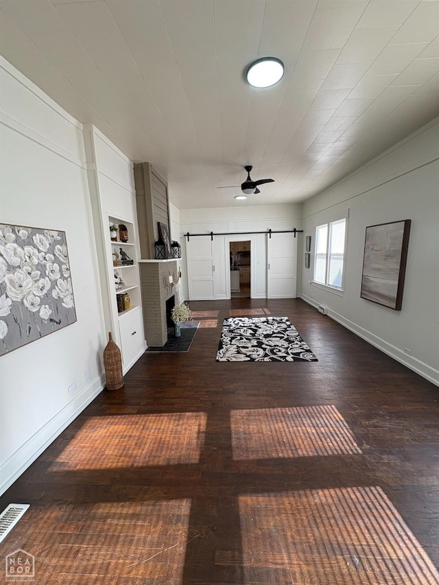 608 W Poplar St W, Paragould, AR 72450 - interior space featuring wood-type flooring, ceiling fan, a barn door, and baseboards