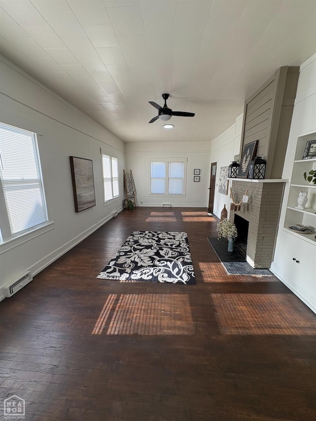 608 W Poplar St W, Paragould, AR 72450 - living room with ceiling fan, baseboard heating, a fireplace, hardwood / wood-style flooring, and baseboards