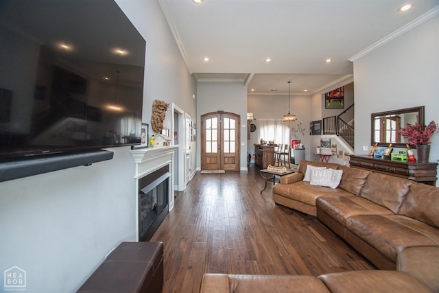 living room with dark wood-style flooring, recessed lighting, french doors, crown molding, and stairs