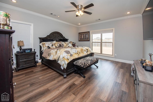 bedroom with dark wood-type flooring, visible vents, baseboards, and ornamental molding