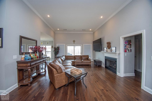 living area featuring baseboards, recessed lighting, a fireplace, crown molding, and dark wood finished floors