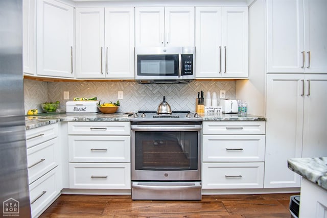 kitchen featuring light stone countertops, dark wood-type flooring, white cabinetry, and appliances with stainless steel finishes