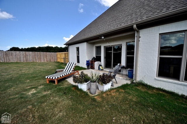 view of yard with fence and a patio