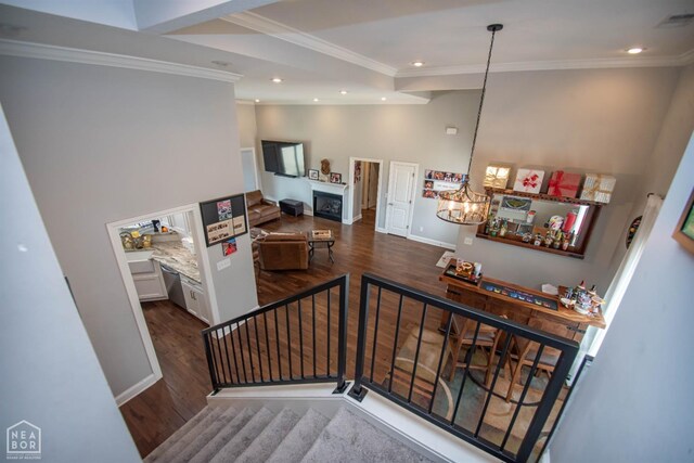 stairs featuring recessed lighting, visible vents, crown molding, and wood finished floors