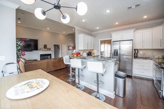 kitchen featuring white cabinets, dark wood finished floors, visible vents, and appliances with stainless steel finishes