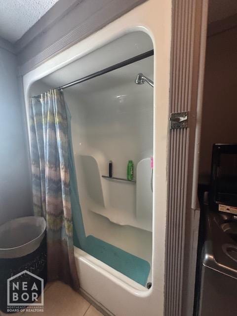 full bath with tile patterned flooring and a textured ceiling