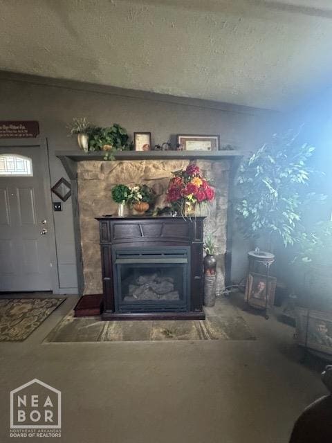 interior space with a fireplace and a textured ceiling