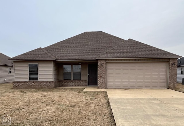 3828 Remington Dr, Jonesboro, AR 72404 - ranch-style house featuring brick siding, a shingled roof, a garage, and concrete driveway