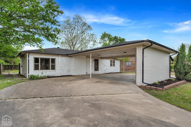 single story home with fence, driveway, and an attached carport
