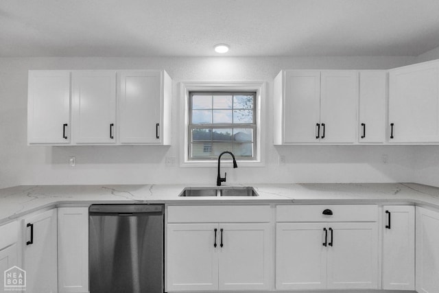 kitchen with a sink, white cabinets, and dishwasher