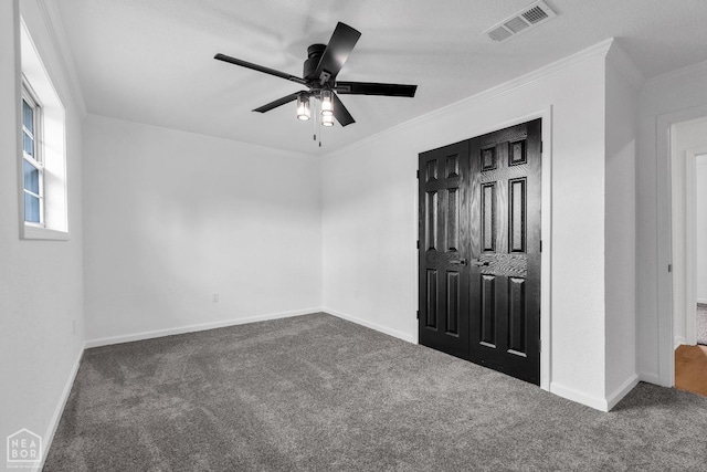 unfurnished bedroom with carpet floors, ornamental molding, and visible vents