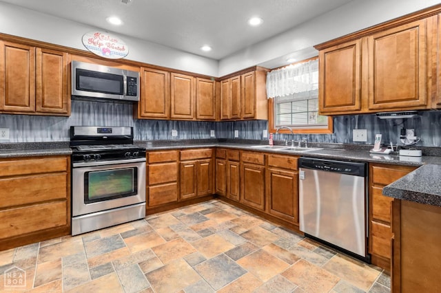 330 Greene 730th Rd, Paragould, AR 72450 - kitchen with appliances with stainless steel finishes, brown cabinets, dark countertops, and recessed lighting