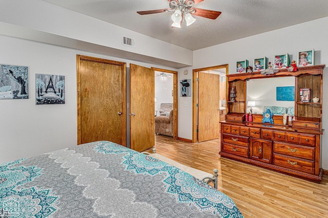 330 Greene 730th Rd, Paragould, AR 72450 - bedroom featuring light wood-style floors, a textured ceiling, and a ceiling fan