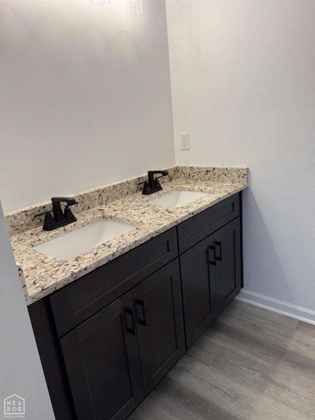 5633 Morgan Dr, Jonesboro, AR 72401 - bathroom with double vanity, wood finished floors, and baseboards