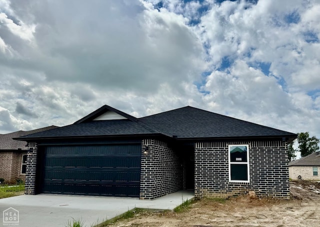 5633 Morgan Dr, Jonesboro, AR 72401 - view of front of property with an attached garage, roof with shingles, brick siding, and driveway