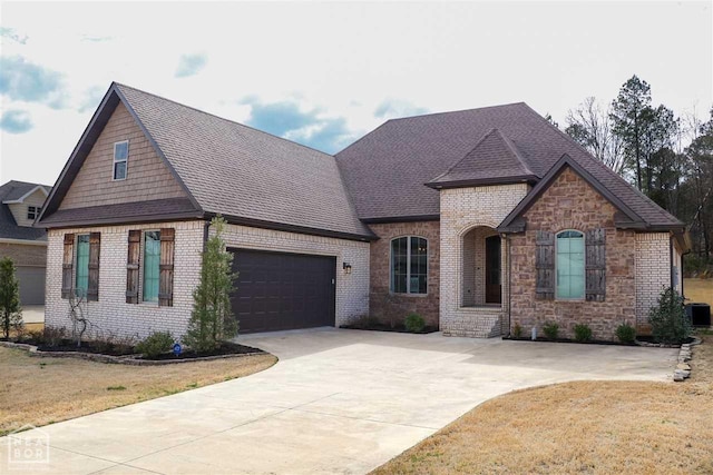 3205 Mallard Pointe Ln, Jonesboro, AR 72404 - view of front of house featuring concrete driveway, brick siding, an attached garage, a shingled roof, and cooling unit