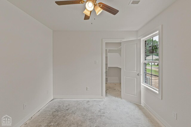 220 Stewart, Monette, AR 72447 - unfurnished bedroom featuring a spacious closet, baseboards, ceiling fan, and a closet
