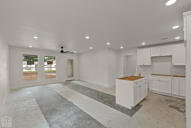 220 Stewart, Monette, AR 72447 - kitchen with recessed lighting, baseboards, a kitchen island, ceiling fan, and white cabinetry