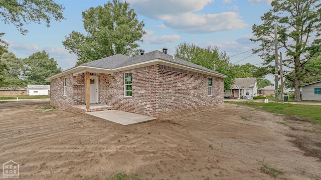 220 Stewart, Monette, AR 72447 - view of home's exterior featuring brick siding and roof with shingles