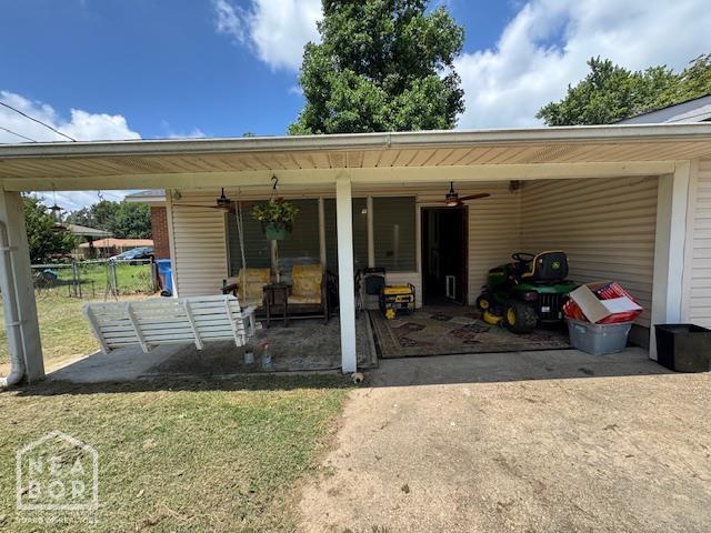 1207 Basil St, Corning, AR 72422 - property entrance with a ceiling fan, an attached carport, and driveway