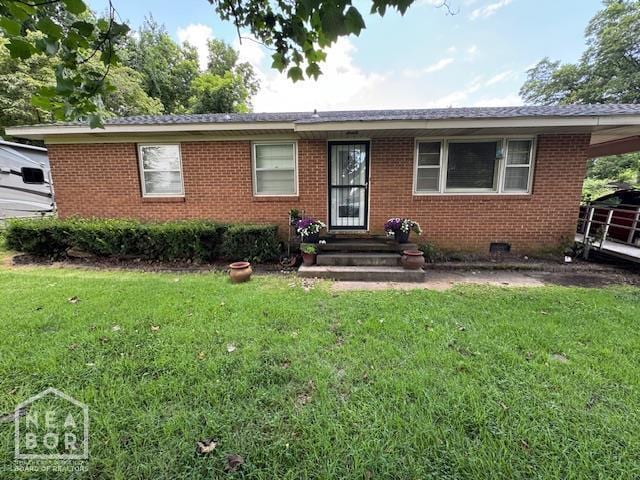 1207 Basil St, Corning, AR 72422 - ranch-style home with a front lawn, brick siding, and a carport