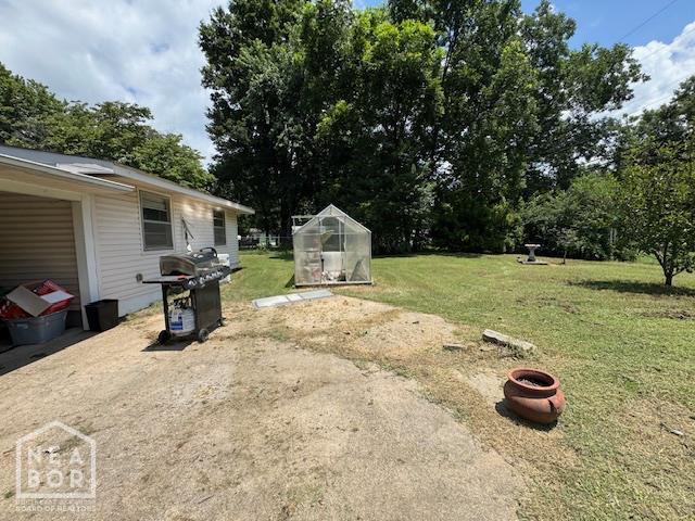1207 Basil St, Corning, AR 72422 - view of grassy yard featuring an exterior structure and an outbuilding