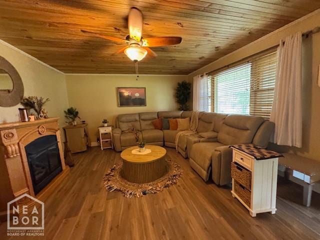 1207 Basil St, Corning, AR 72422 - living room with wood ceiling, ceiling fan, a glass covered fireplace, wood finished floors, and ornamental molding