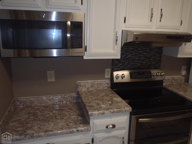 1201 Nancy Ave, Newport, AR 72112 - kitchen featuring appliances with stainless steel finishes, exhaust hood, and white cabinetry