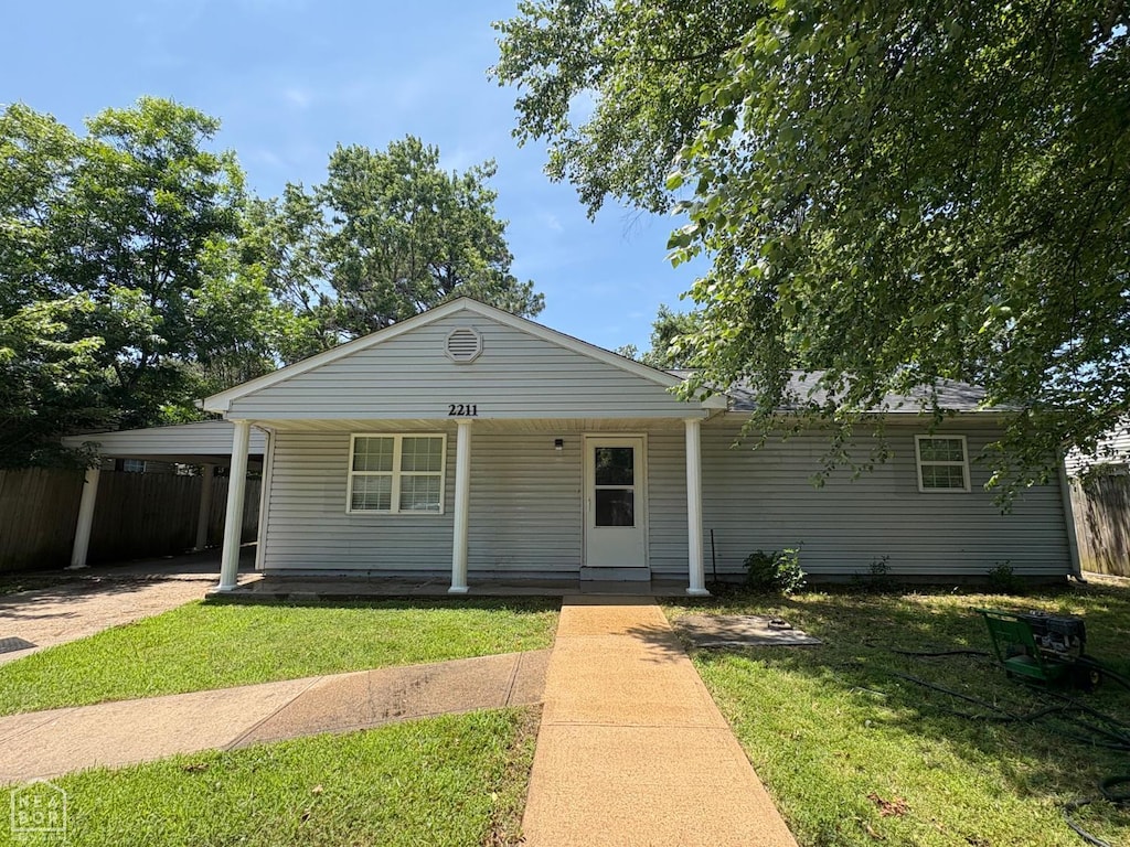 2211 Sutton Dr, Jonesboro, AR 72401 - view of front of house with a carport and covered porch