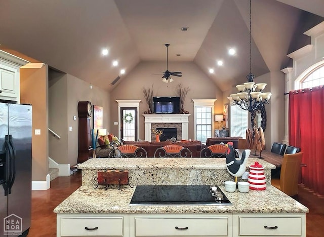 2301 Westminster Way, Jonesboro, AR 72401 - kitchen with stainless steel refrigerator with ice dispenser, black electric cooktop, open floor plan, a chandelier, and a ceiling fan