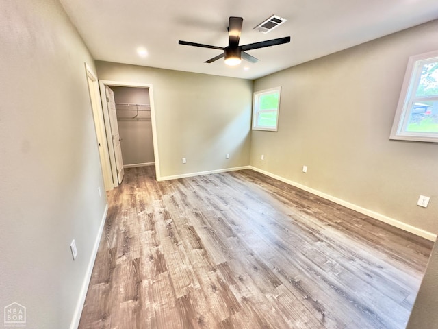 377 N 3rd St, Black Rock, AR 72415 - unfurnished bedroom featuring wood finished floors, a spacious closet, a ceiling fan, and a closet