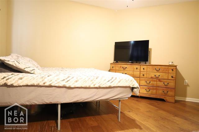 5703 Cedar St, Paragould, AR 72450 - bedroom with wood finished floors and baseboards