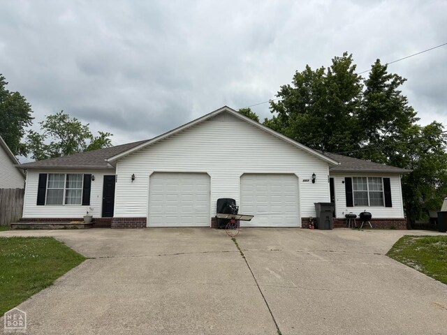 5703 Cedar St, Paragould, AR 72450 - ranch-style house featuring an attached garage, roof with shingles, and concrete driveway