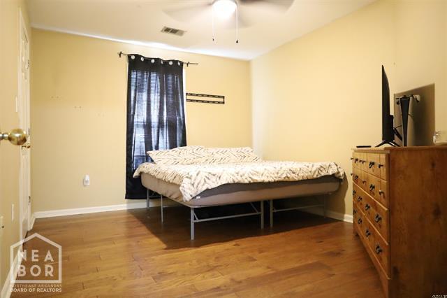 5703 Cedar St, Paragould, AR 72450 - bedroom with wood finished floors and baseboards