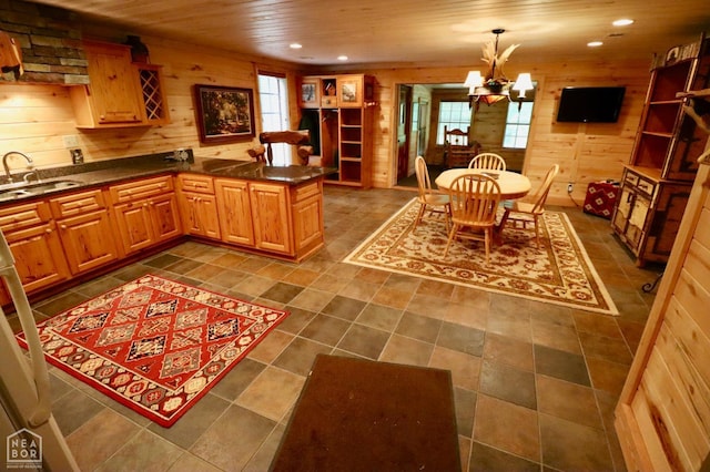 0 Cokley Rd, Warm Springs, AR 72478 - kitchen with wooden walls, plenty of natural light, a chandelier, a sink, and dark countertops