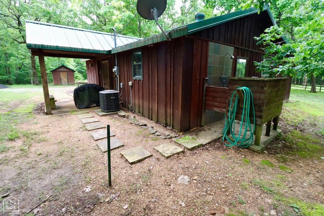 0 Cokley Rd, Warm Springs, AR 72478 - view of side of home featuring board and batten siding and central AC