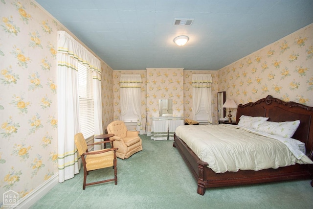 carpeted bedroom with wallpapered walls, baseboards, and visible vents