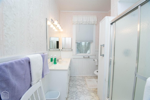 full bathroom with a shower stall, wainscoting, vanity, wallpapered walls, and marble finish floor