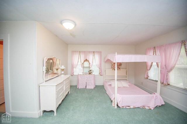 bedroom with carpet floors and baseboards