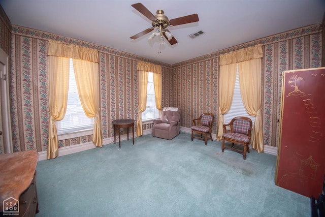sitting room featuring ceiling fan, visible vents, carpet flooring, wallpapered walls, and baseboards