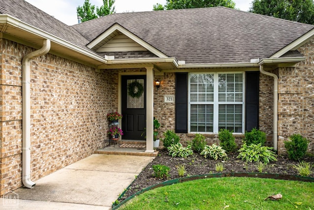 321 Crestfield Dr, Jonesboro, AR 72404 - view of exterior entry featuring brick siding and a shingled roof