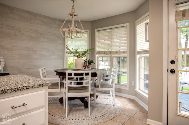321 Crestfield Dr, Jonesboro, AR 72404 - dining room featuring wood walls, healthy amount of natural light, light tile patterned floors, and a chandelier