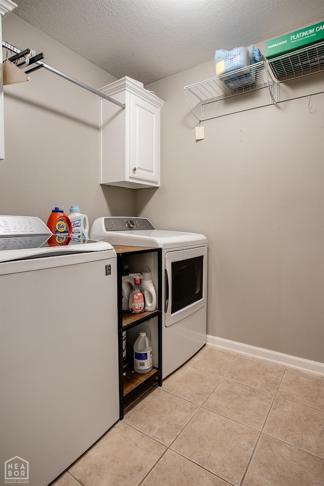 321 Crestfield Dr, Jonesboro, AR 72404 - laundry area with washer and dryer, cabinet space, light tile patterned floors, and a textured ceiling