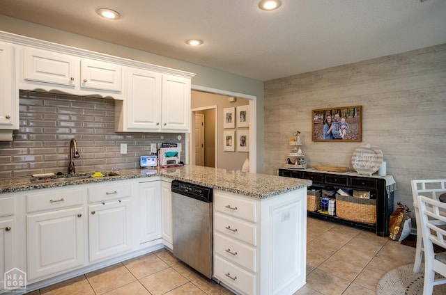 321 Crestfield Dr, Jonesboro, AR 72404 - kitchen with stainless steel dishwasher, a peninsula, light tile patterned flooring, light stone countertops, and backsplash