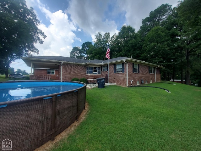 691 Crestline Dr, Piggott, AR 72454 - back of house featuring brick siding, a lawn, a chimney, and an outdoor pool
