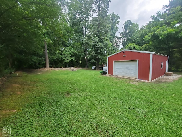691 Crestline Dr, Piggott, AR 72454 - view of grassy yard featuring a garage, an outdoor structure, and driveway